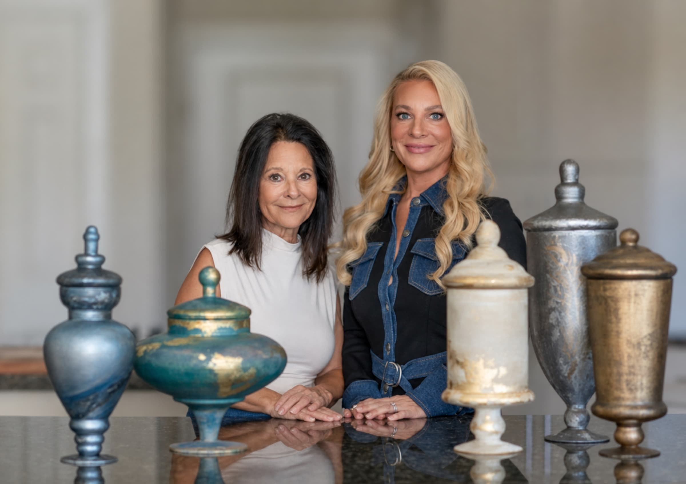 Monarch Legacy founders Kristen Kuyper and Denise Caliva with five artist-made memorial vessels