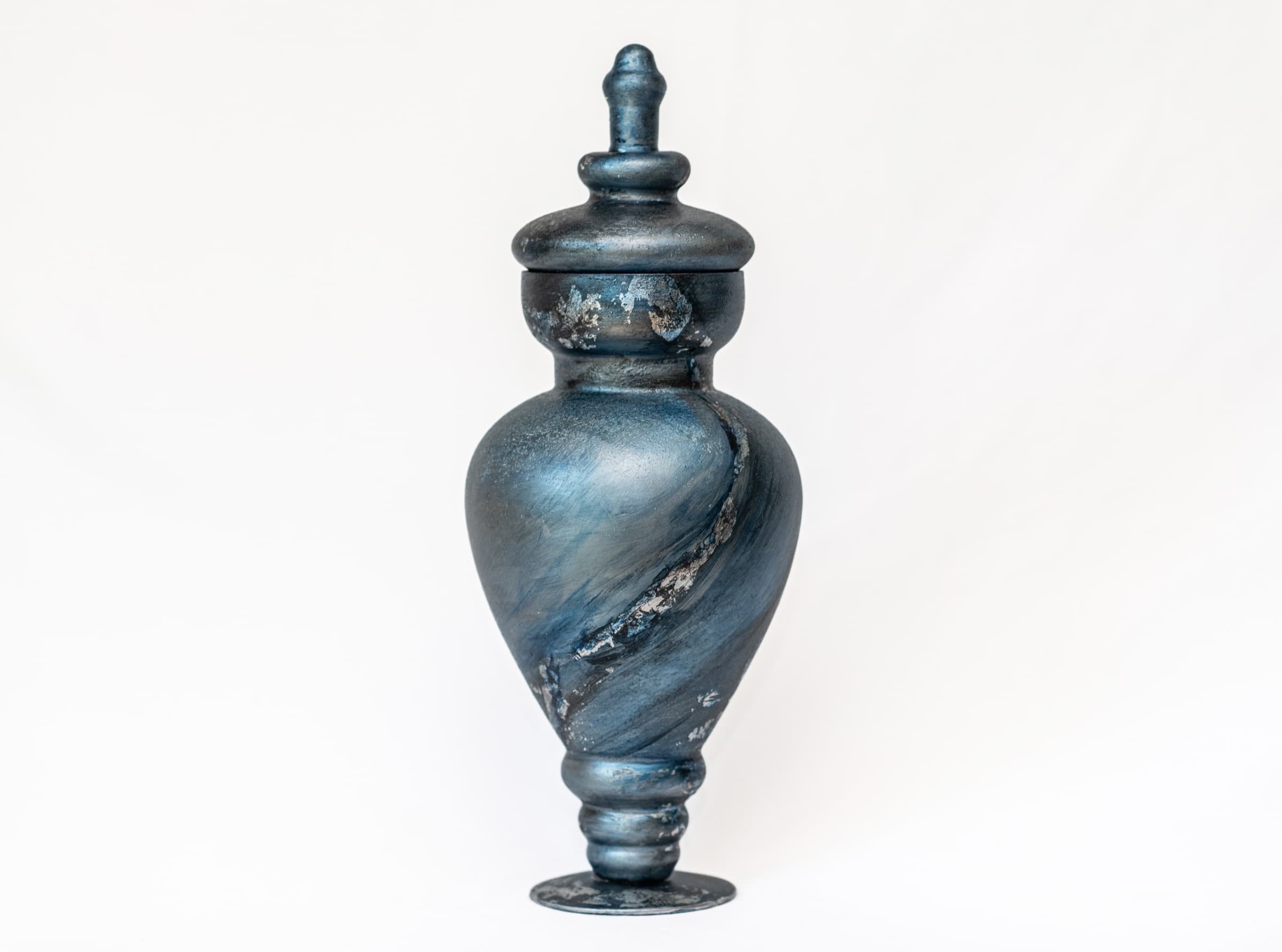 Deep blue sculptural memorial vessel with a sweeping silver detail