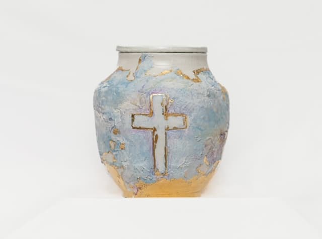 Pale blue and ivory memorial vessel with a restrained cross motif